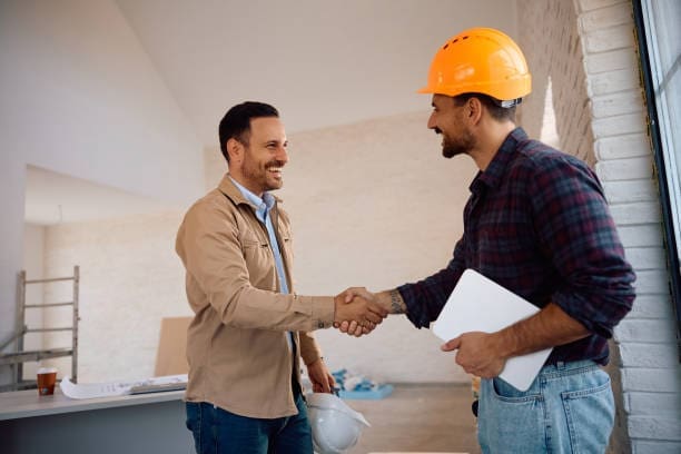 Photo of a project manager and a customer shaking hands