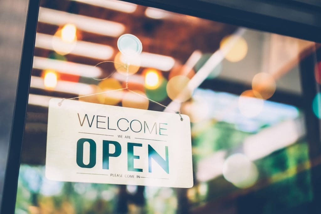 a welcome open sign close up on the door of a shop or premesis
