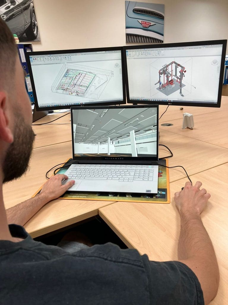 Photo of a person looking at technical designs on a computer